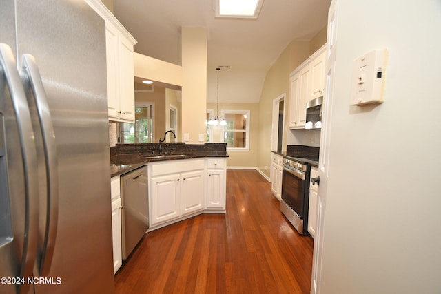 kitchen featuring stainless steel appliances, dark wood-type flooring, sink, and white cabinetry