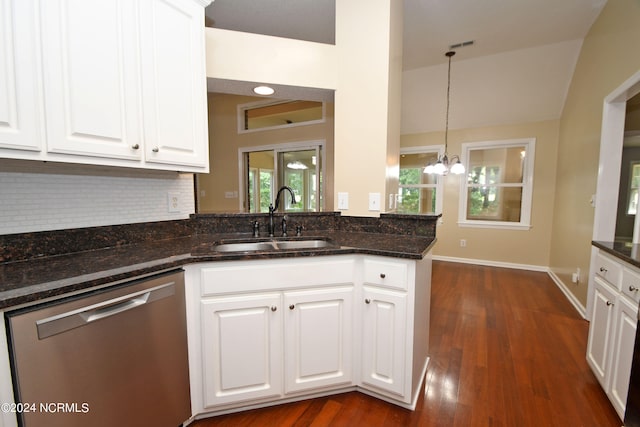 kitchen featuring dark stone countertops, white cabinetry, kitchen peninsula, dishwasher, and sink