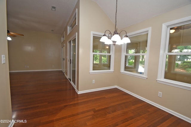 interior space with ceiling fan with notable chandelier, vaulted ceiling, dark hardwood / wood-style floors, and a wealth of natural light