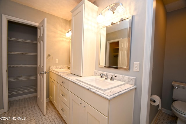 bathroom with tile patterned floors, vanity, and toilet