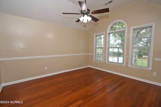 empty room with vaulted ceiling, dark wood-type flooring, and ceiling fan