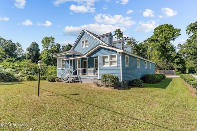 view of front facade with covered porch and a front yard