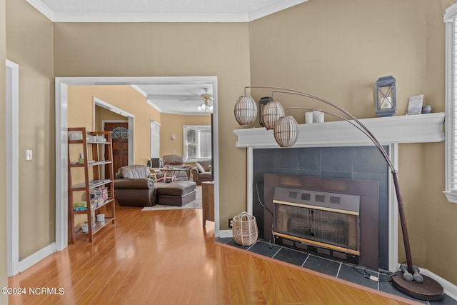 details with a fireplace, hardwood / wood-style floors, ceiling fan, and ornamental molding