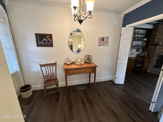 interior space featuring ornamental molding, an inviting chandelier, and dark hardwood / wood-style flooring