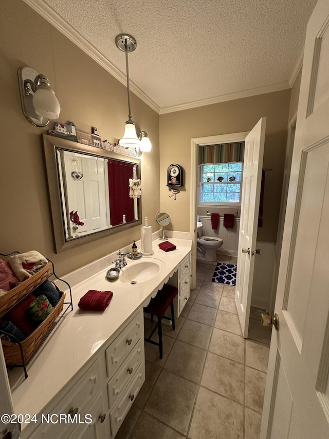 bathroom with vanity, a textured ceiling, toilet, and crown molding