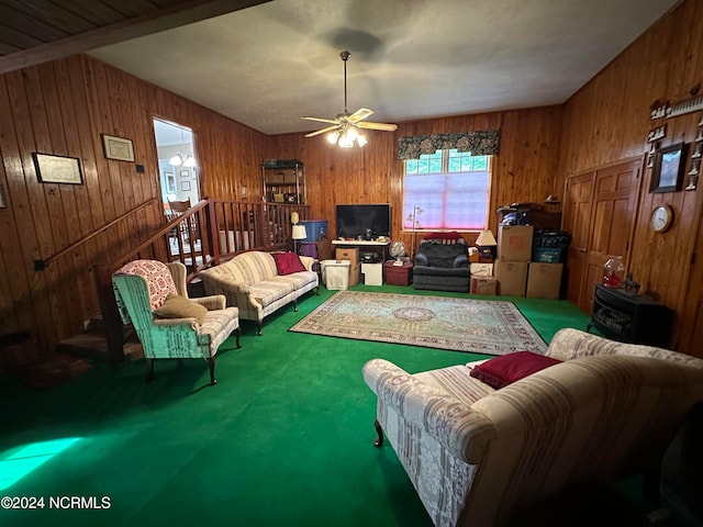 carpeted living room with wooden walls and ceiling fan