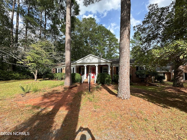 neoclassical / greek revival house with a front lawn