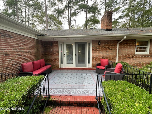 view of exterior entry featuring an outdoor living space