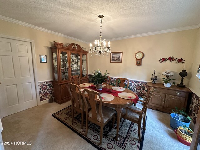 carpeted dining area featuring ornamental molding, a notable chandelier, and a textured ceiling