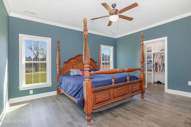 bedroom with ornamental molding, a closet, ceiling fan, and hardwood / wood-style flooring