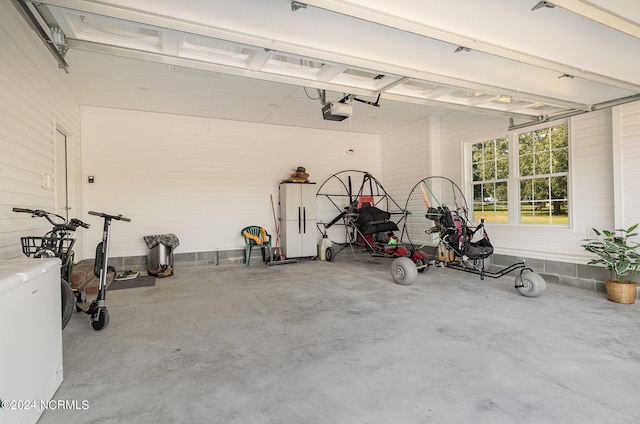 garage with a garage door opener and fridge