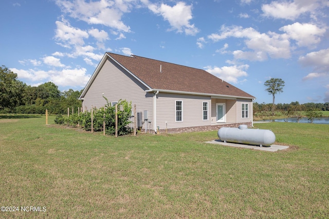 rear view of property featuring a lawn