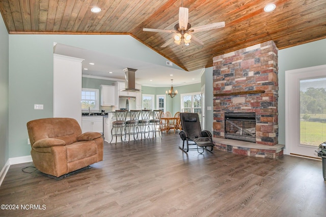 living room featuring wood-type flooring, sink, a wealth of natural light, and wood ceiling