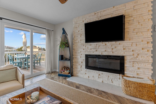 unfurnished living room featuring a textured ceiling, a fireplace, and hardwood / wood-style floors