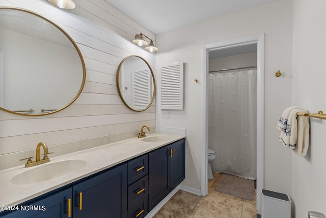 bathroom with tile patterned floors, walk in shower, vanity, and toilet