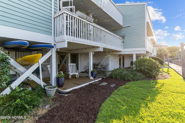 view of property exterior featuring a deck and a yard