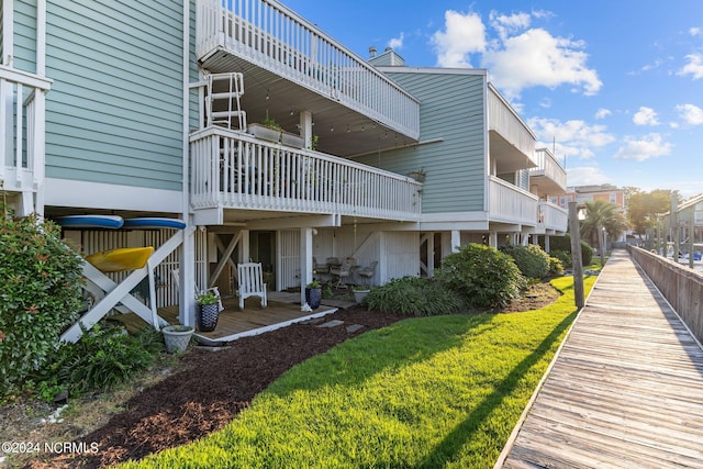 exterior space with a lawn and a balcony