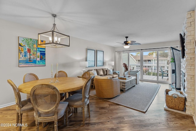 dining area with ceiling fan with notable chandelier and hardwood / wood-style floors