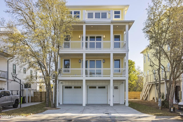 beach home featuring a balcony and a garage