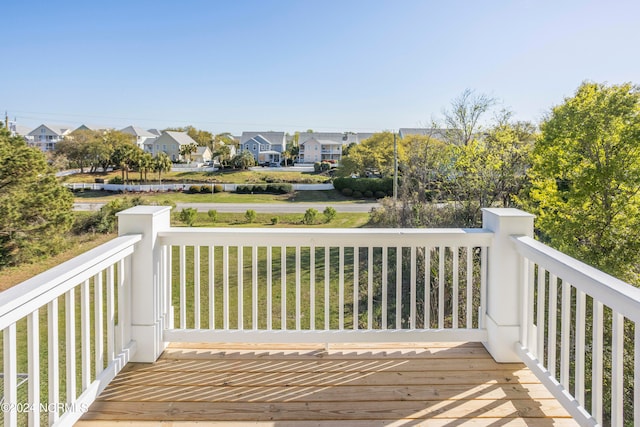 wooden deck with a lawn