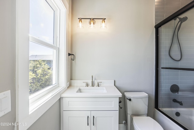 bathroom with bathtub / shower combination, toilet, and vanity