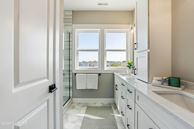 bathroom featuring vanity, tile patterned floors, and a shower with door