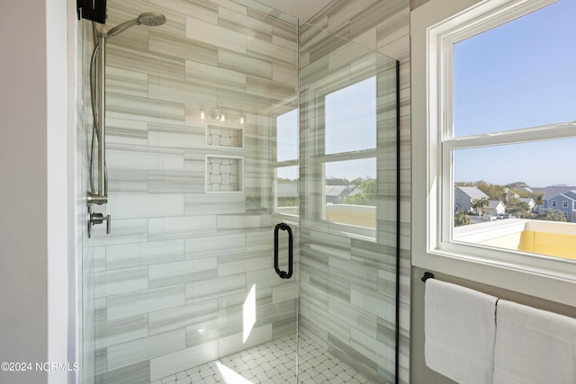 bathroom featuring a shower with door