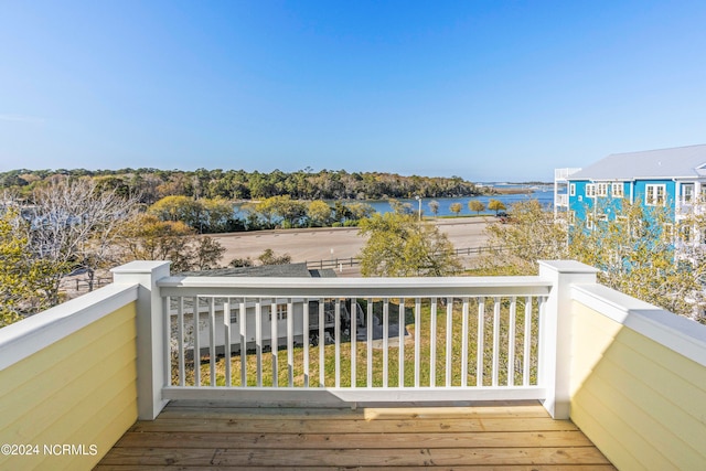 wooden terrace featuring a water view