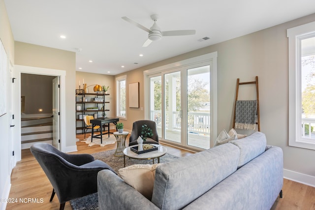 living room with ceiling fan, light hardwood / wood-style flooring, and a healthy amount of sunlight