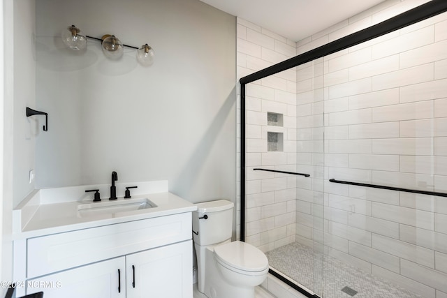 bathroom with vanity, toilet, and an enclosed shower