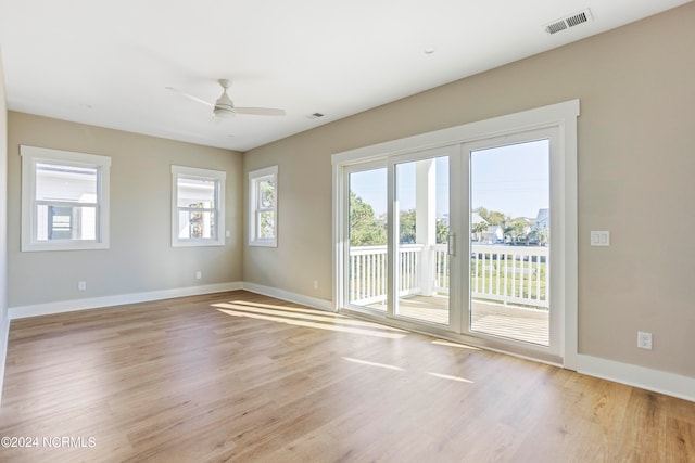 spare room with ceiling fan and light hardwood / wood-style floors