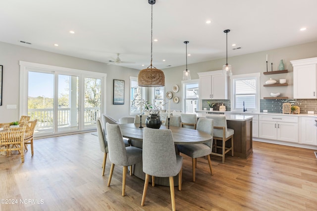 dining area with plenty of natural light, ceiling fan, and light wood-type flooring