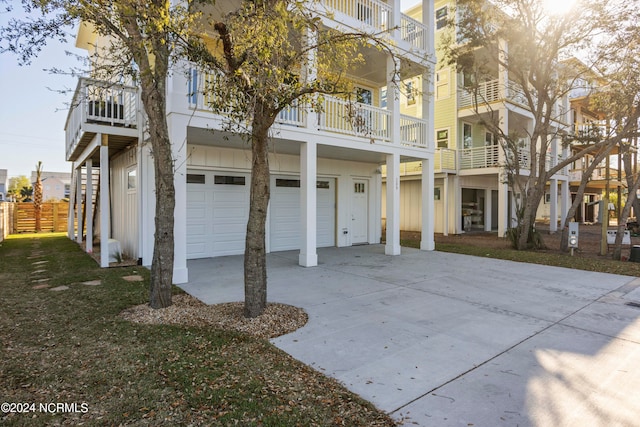 view of front facade with a garage and a balcony