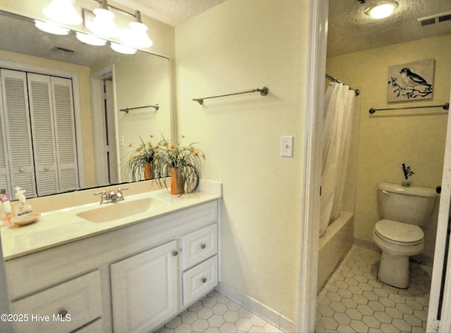 bathroom featuring a textured ceiling, toilet, vanity, visible vents, and a closet