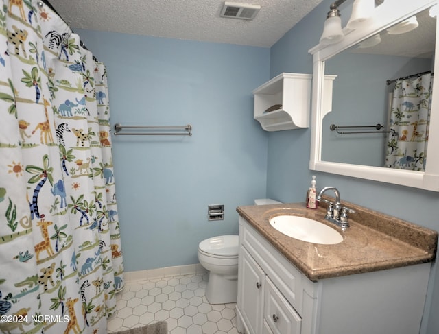 bathroom with visible vents, toilet, a textured ceiling, vanity, and baseboards