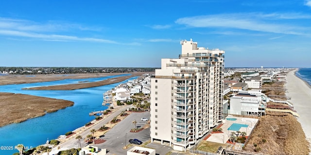 drone / aerial view featuring a water view and a beach view