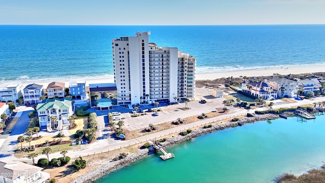 birds eye view of property featuring a beach view and a water view