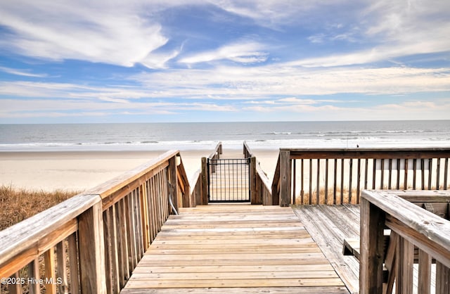 view of property's community with a water view and a view of the beach