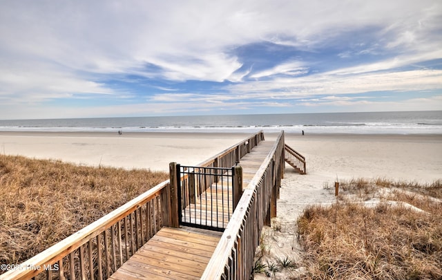 surrounding community with a beach view and a water view