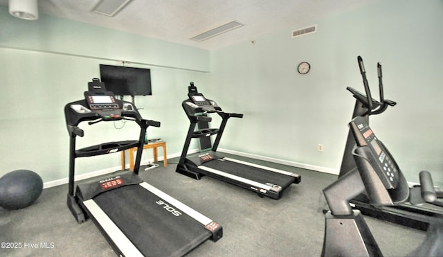 exercise area with baseboards and visible vents