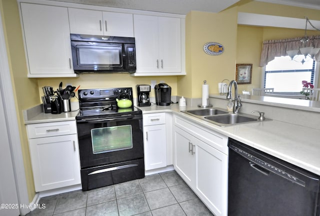 kitchen featuring white cabinets, light countertops, a sink, and black appliances