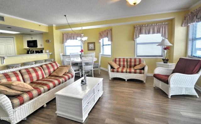 living area featuring visible vents, ornamental molding, dark wood finished floors, and a wealth of natural light