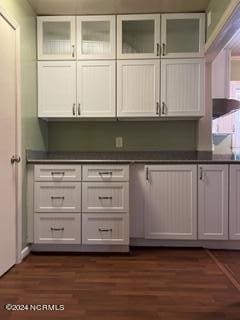 bar featuring white cabinetry and dark wood-type flooring