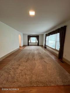 unfurnished room featuring hardwood / wood-style floors and a healthy amount of sunlight