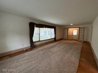 unfurnished room with wood-type flooring