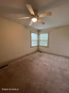 spare room featuring carpet floors and ceiling fan