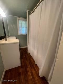 bathroom with vanity, hardwood / wood-style floors, and curtained shower