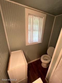 bathroom featuring hardwood / wood-style flooring and toilet