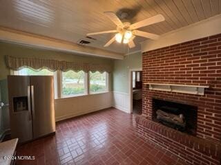 unfurnished living room featuring wood ceiling, a brick fireplace, and ceiling fan