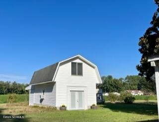 exterior space featuring a lawn and an outbuilding